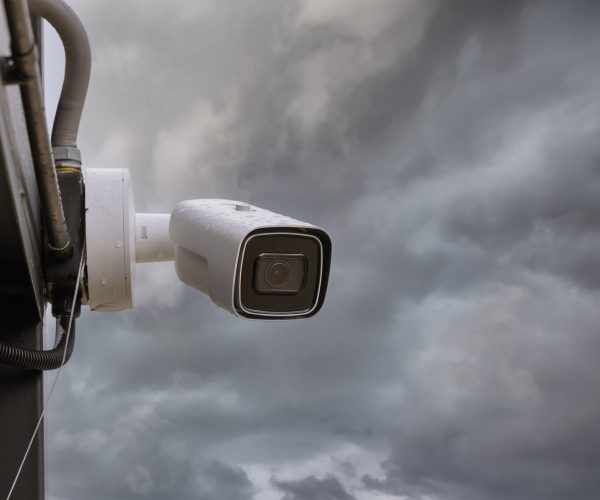 Online Security CCTV camera surveillance system outdoor of house. A blurred night city scape background. Real time Modern CCTV camera on a pole. Equipment system service for safety life or asset.